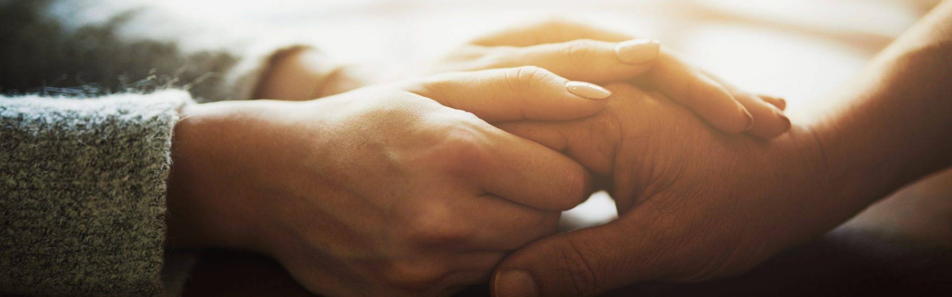 two-people-hold-hands-while-discussing-osteopathy-treatment